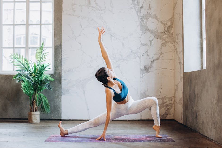 Calm woman performing a seated yoga twist in a brightly lit, modern studio.